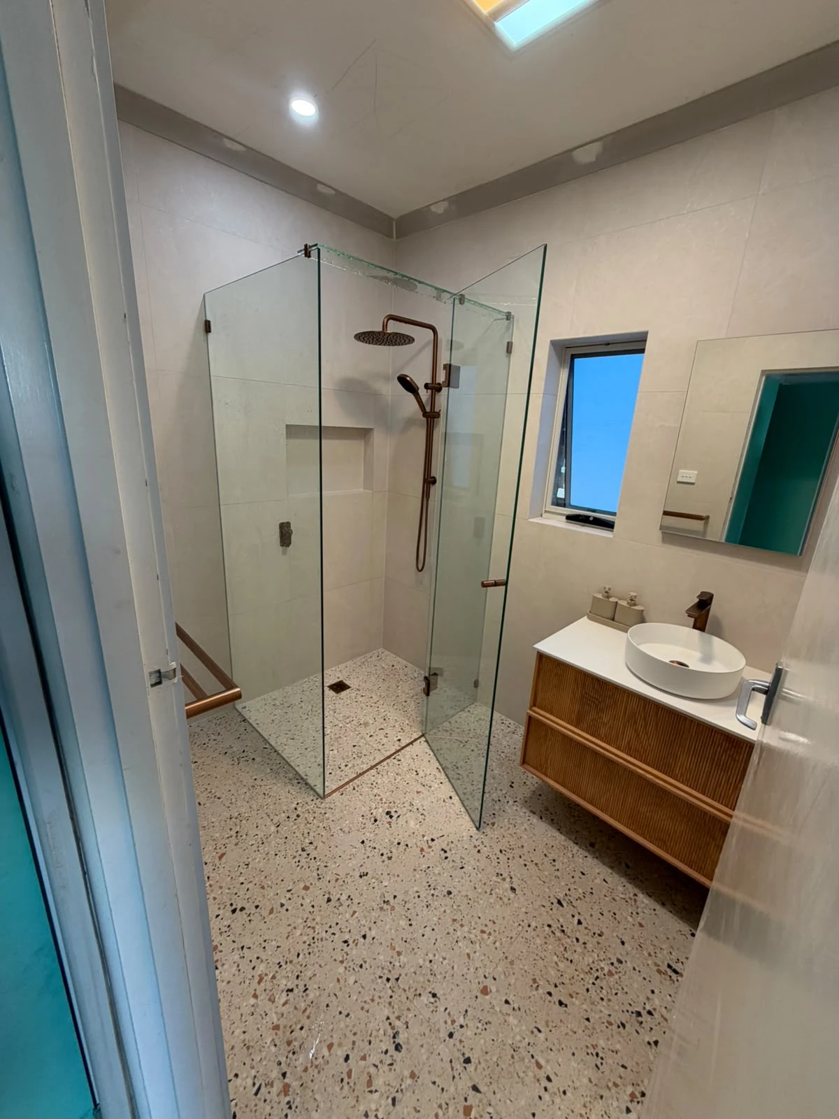 Renovated Fawkner bathroom with a fluted timber vanity and walk-in shower