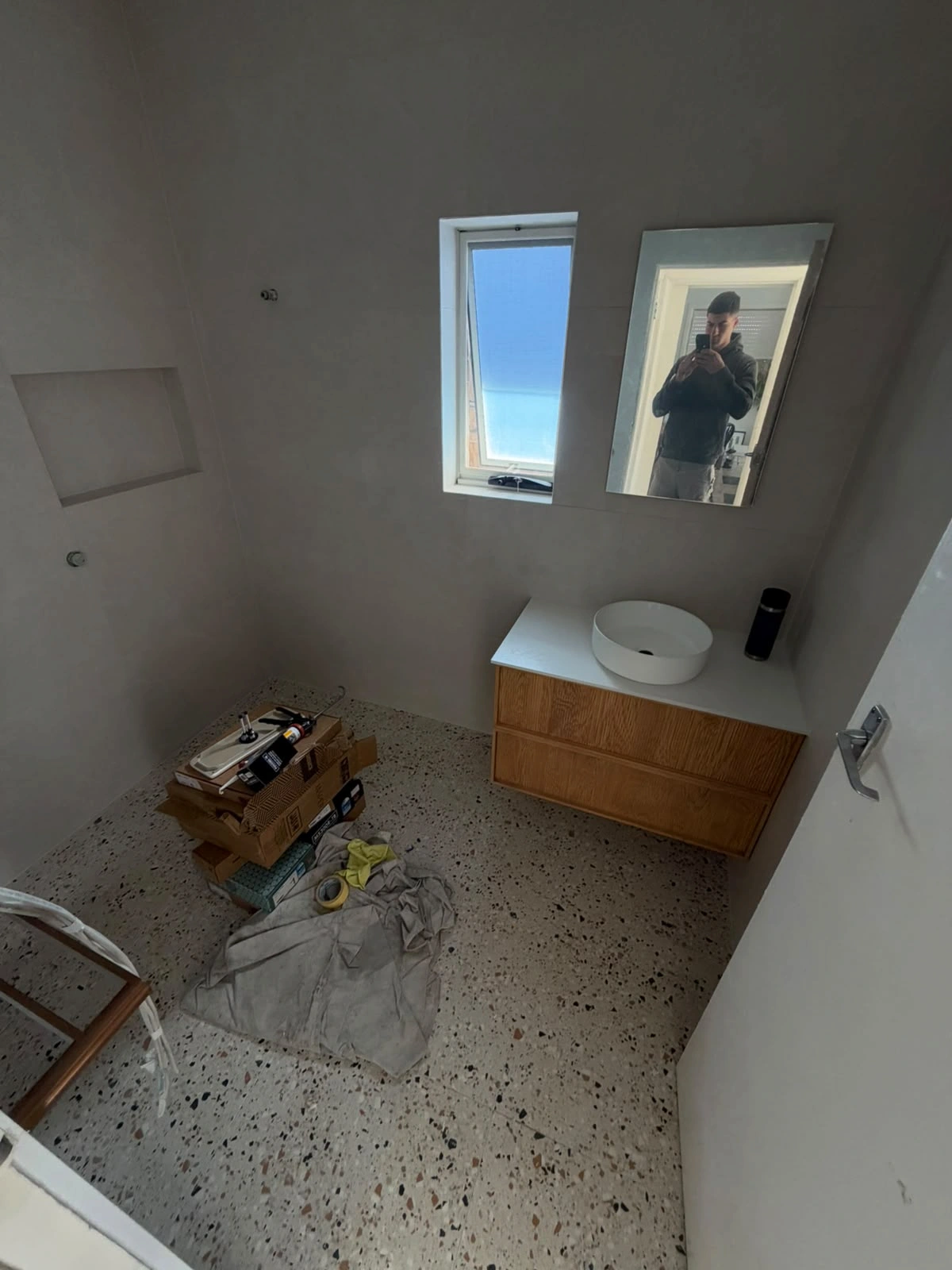 Terrazzo-look floor tiles and timber-look vanity being installed in the Fawkner bathroom