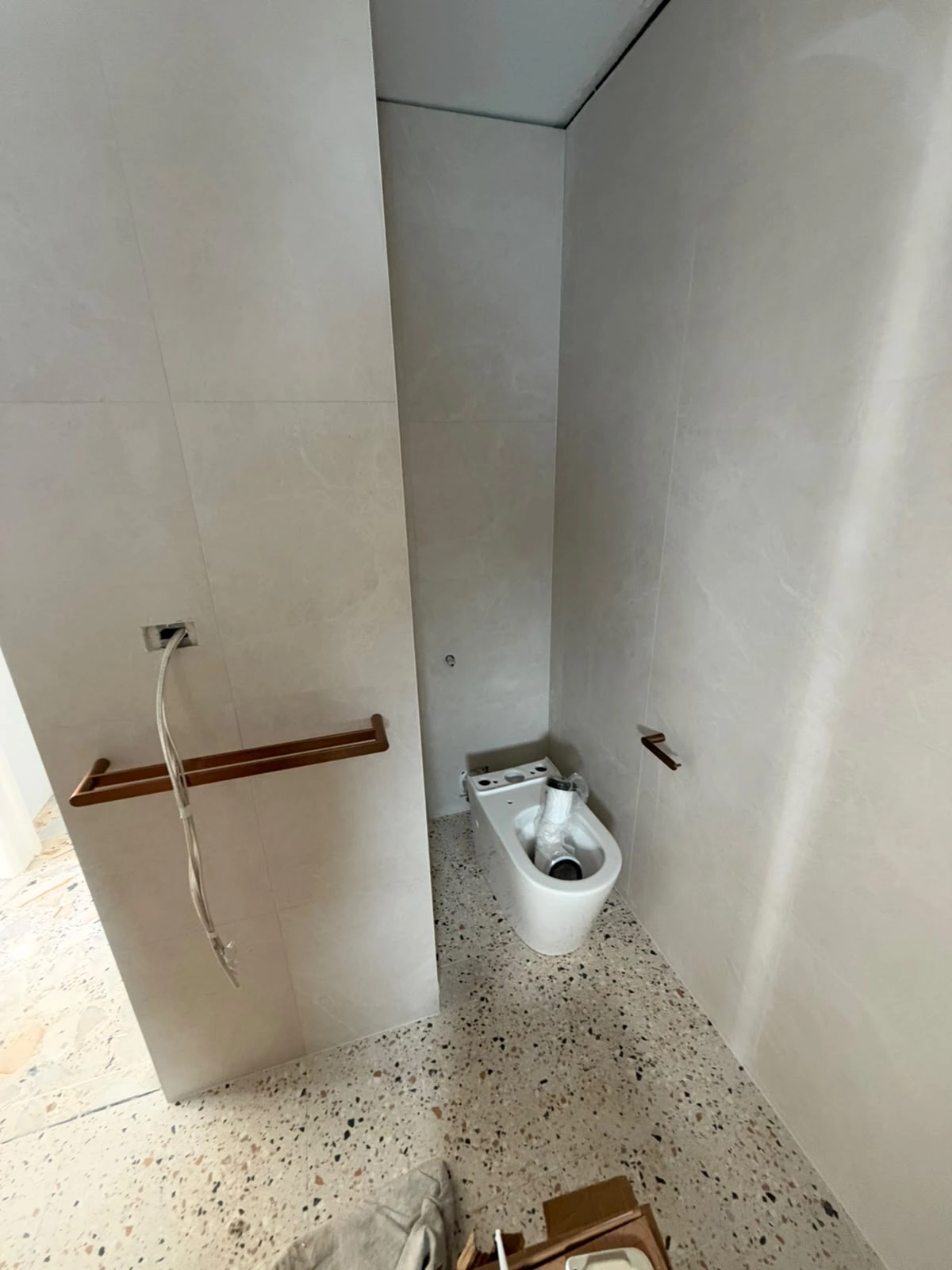 New toilet being installed inside the recessed area of the Fawkner bathroom